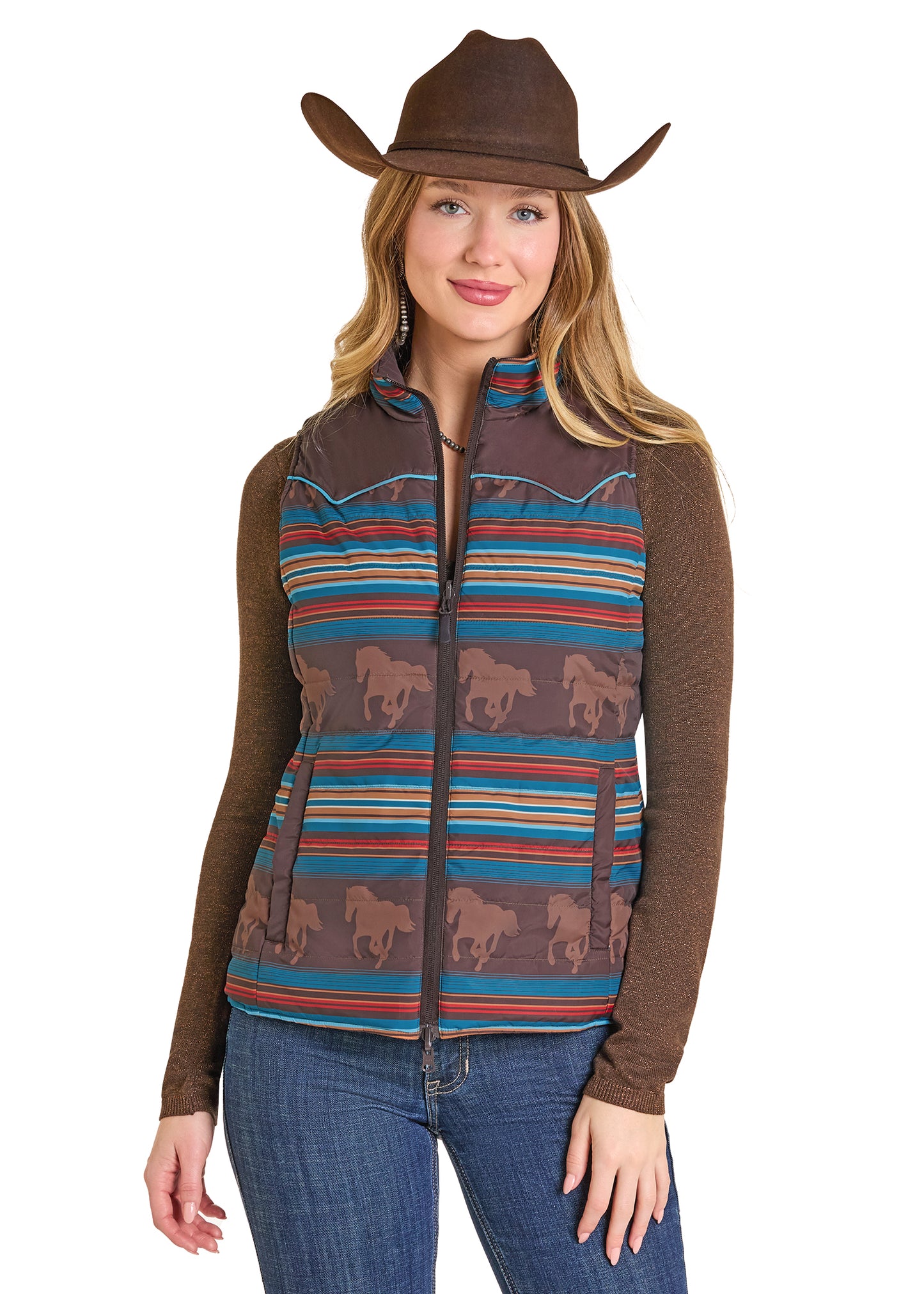 Woman wearing a patterned vest with horse designs and a cowboy hat on a white background