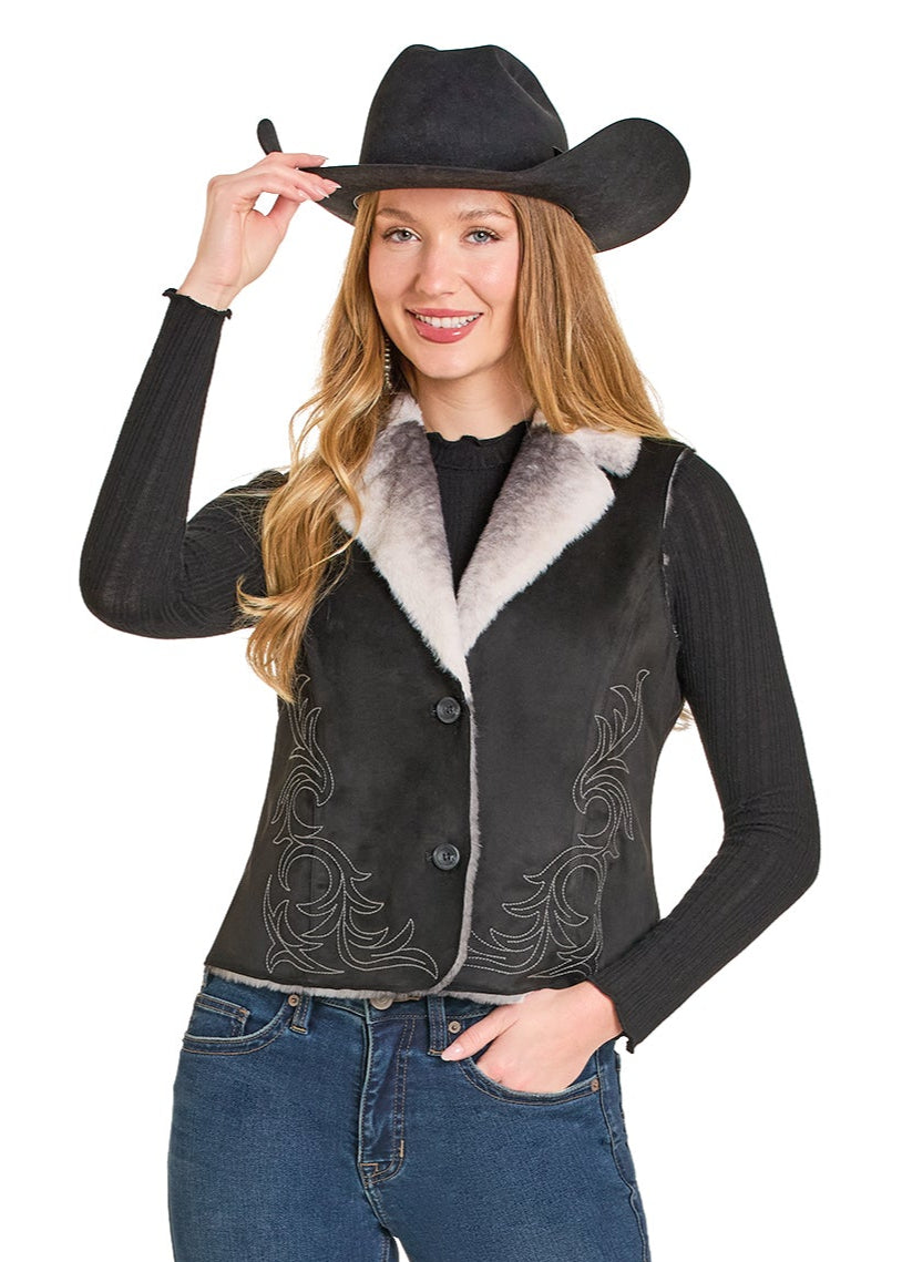 Woman wearing a black embroidered vest with gray fur collar and a cowboy hat on a white background