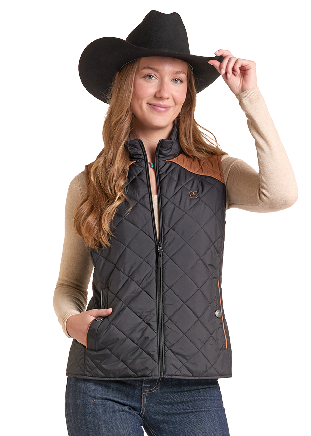 A woman in a black quilted vest with brown shoulder panels, a black cowboy hat, and a beige long-sleeve shirt.