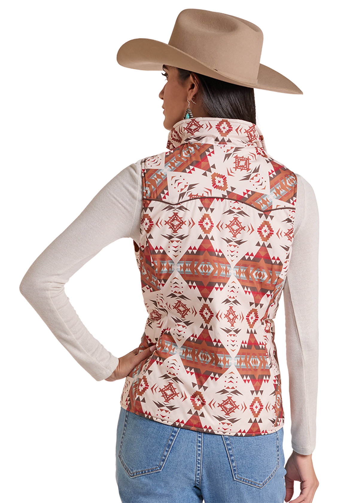 A woman shown from the back wearing a sleeveless western vest with a geometric pattern, paired with a beige cowboy hat, white long-sleeve top, and blue jeans.