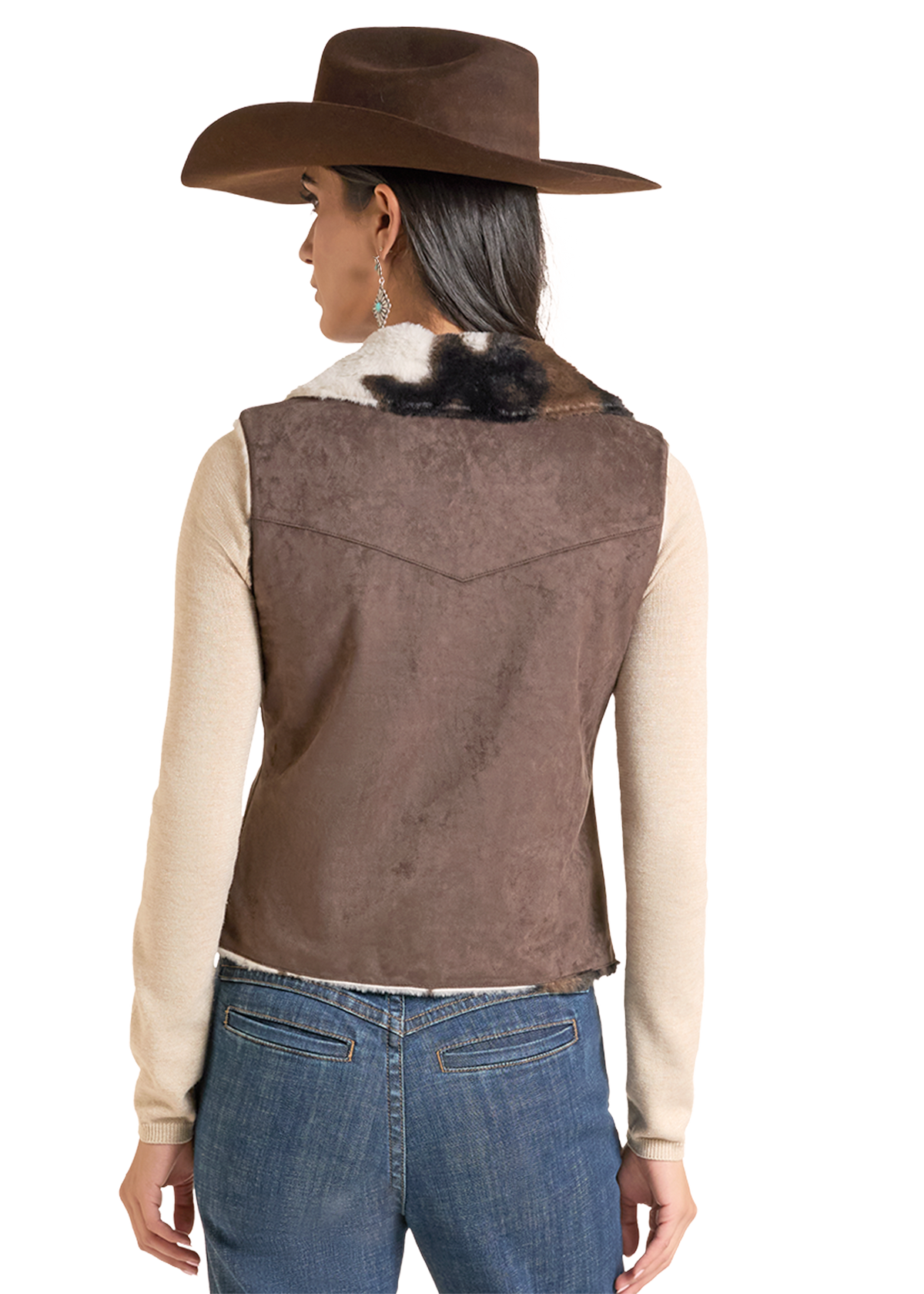 A woman shown from the back wearing a brown suede-like western vest with a white fur collar, a brown cowboy hat.