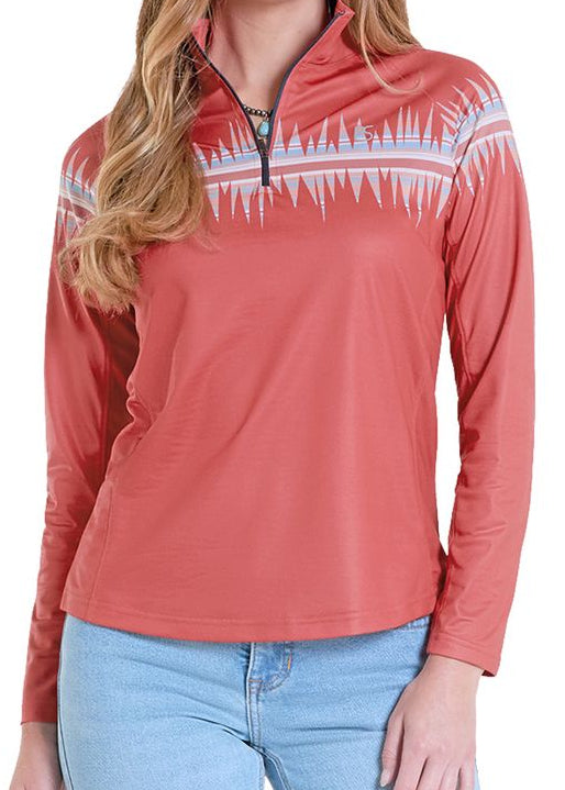 Woman wearing a red long-sleeve shirt with a white pattern, light blue jeans, and a white cowboy hat on a white background.