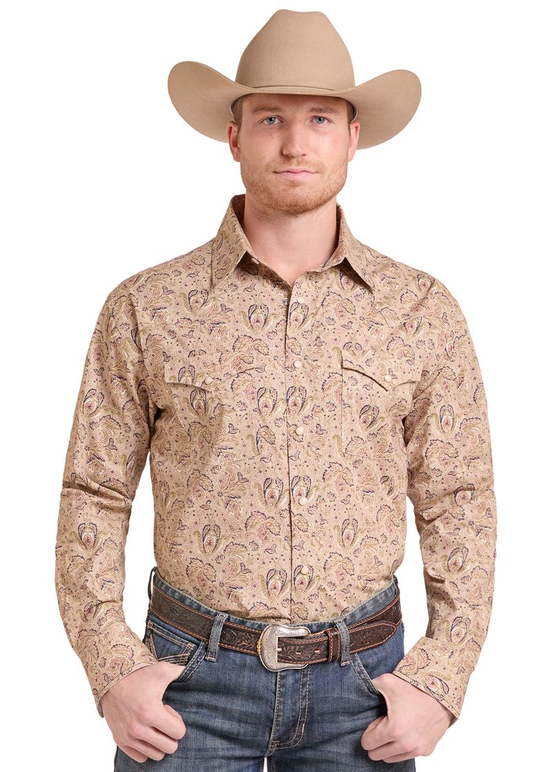 A man wearing a tan cowboy hat, a beige long-sleeve western shirt with a brown paisley pattern.