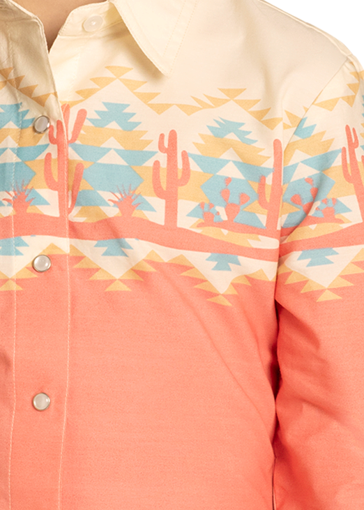 Young girl wearing a coral embroidered shirt, jeans, and a beige cowboy hat on a white background