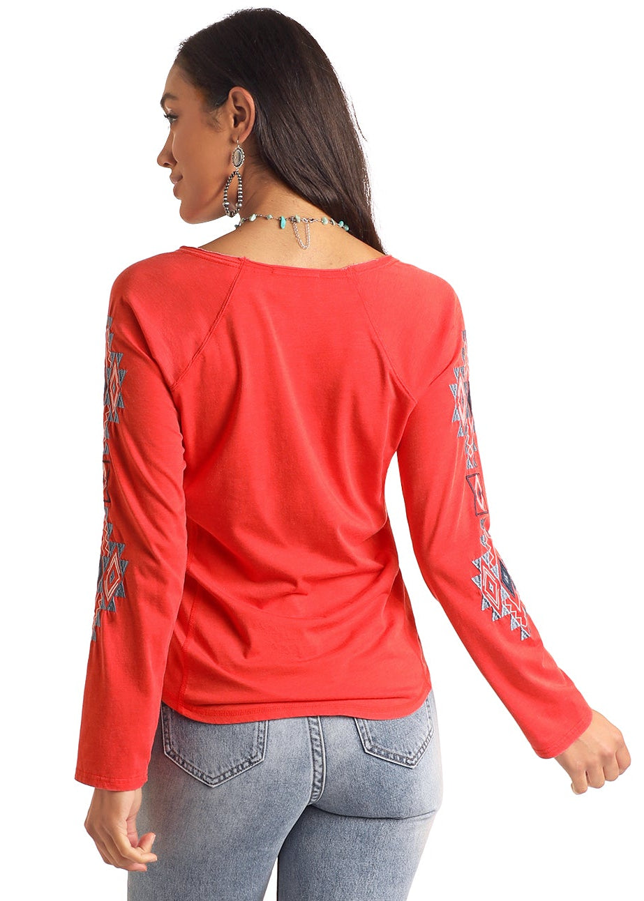 Woman wearing a red top and blue jeans on a white background