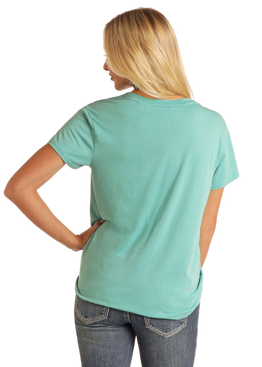 Woman wearing a light green t-shirt and blue jeans on a white background