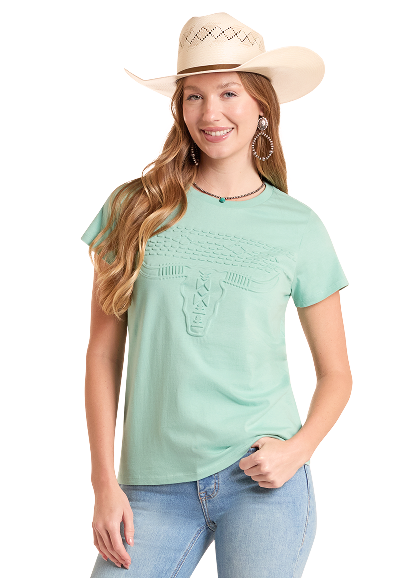 Woman wearing a light green t-shirt, blue jeans, and a beige cowboy hat on a white background