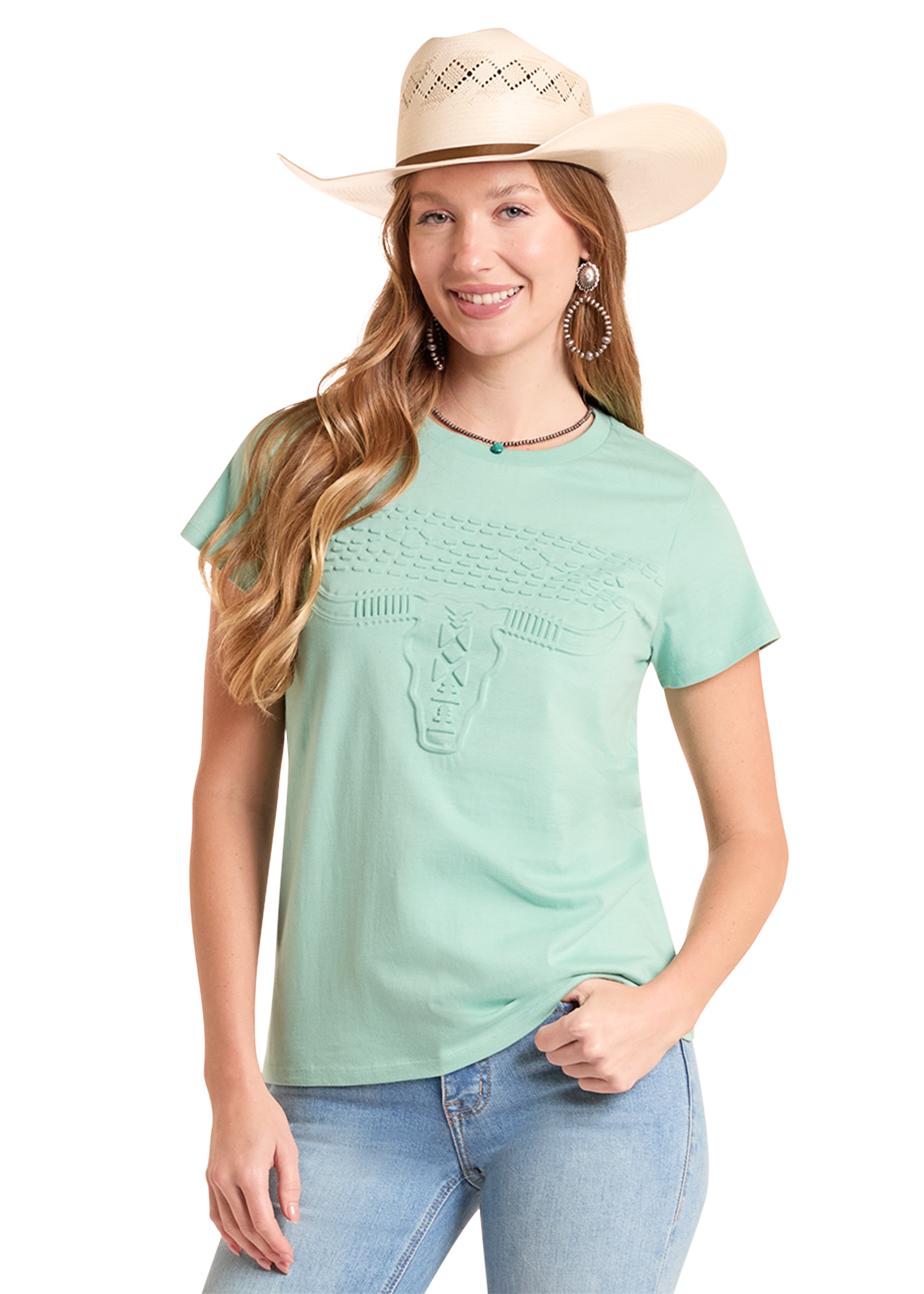 Woman wearing a light green t-shirt, blue jeans, and a beige cowboy hat on a white background