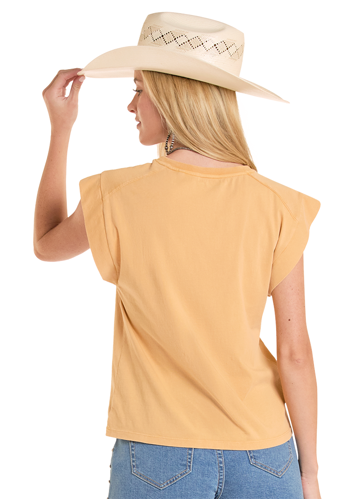 Woman wearing a yellow top and blue jeans with a beige cowboy hat on a white background