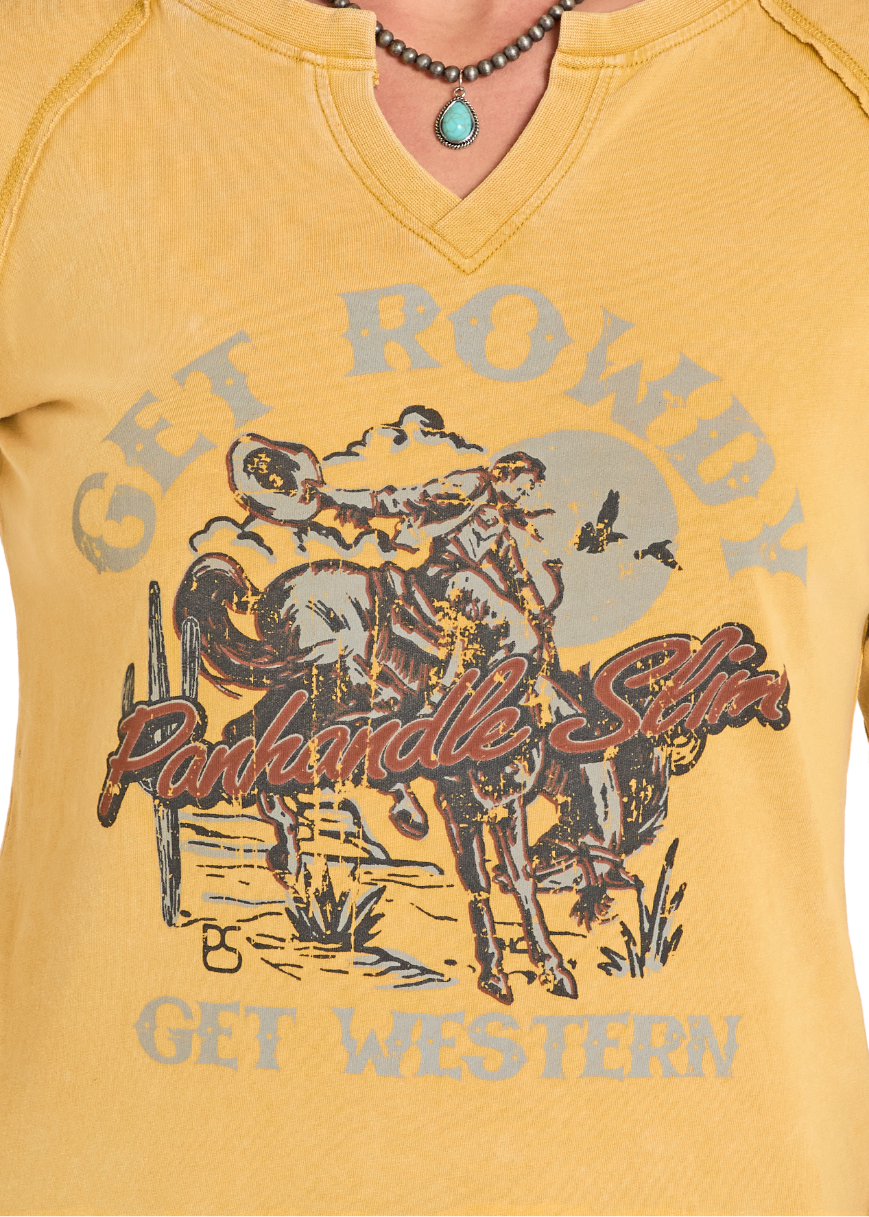 Yellow t-shirt with a graphic design and text on a person wearing it.