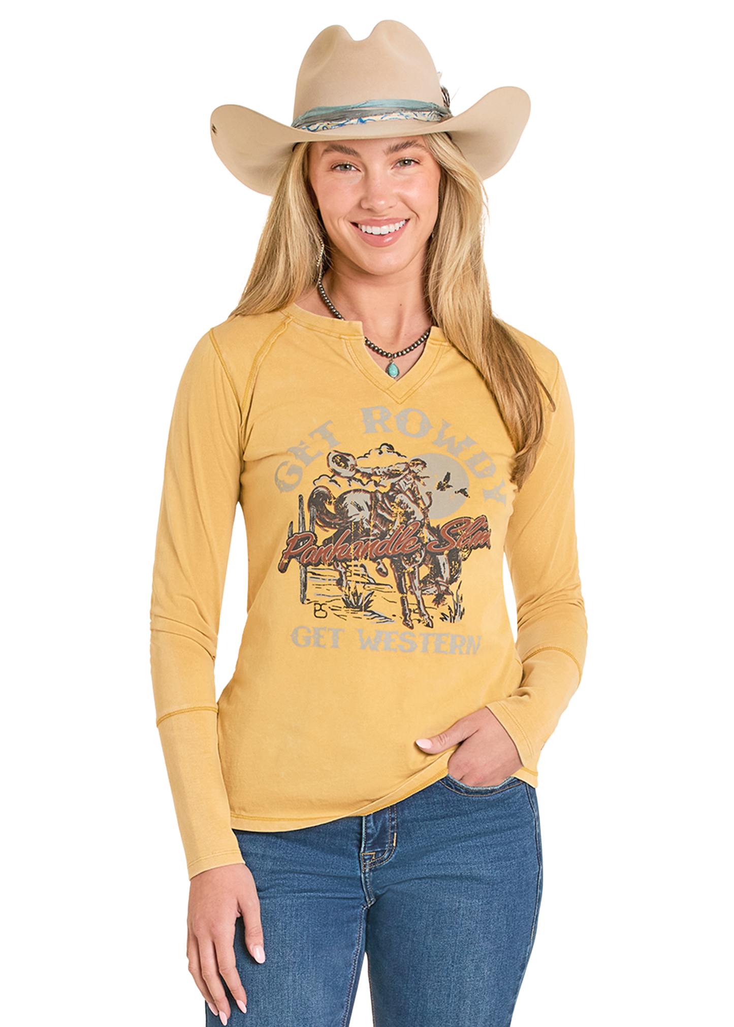 Woman wearing a yellow long-sleeve shirt with a graphic design, blue jeans, and a beige cowboy hat on a white background.