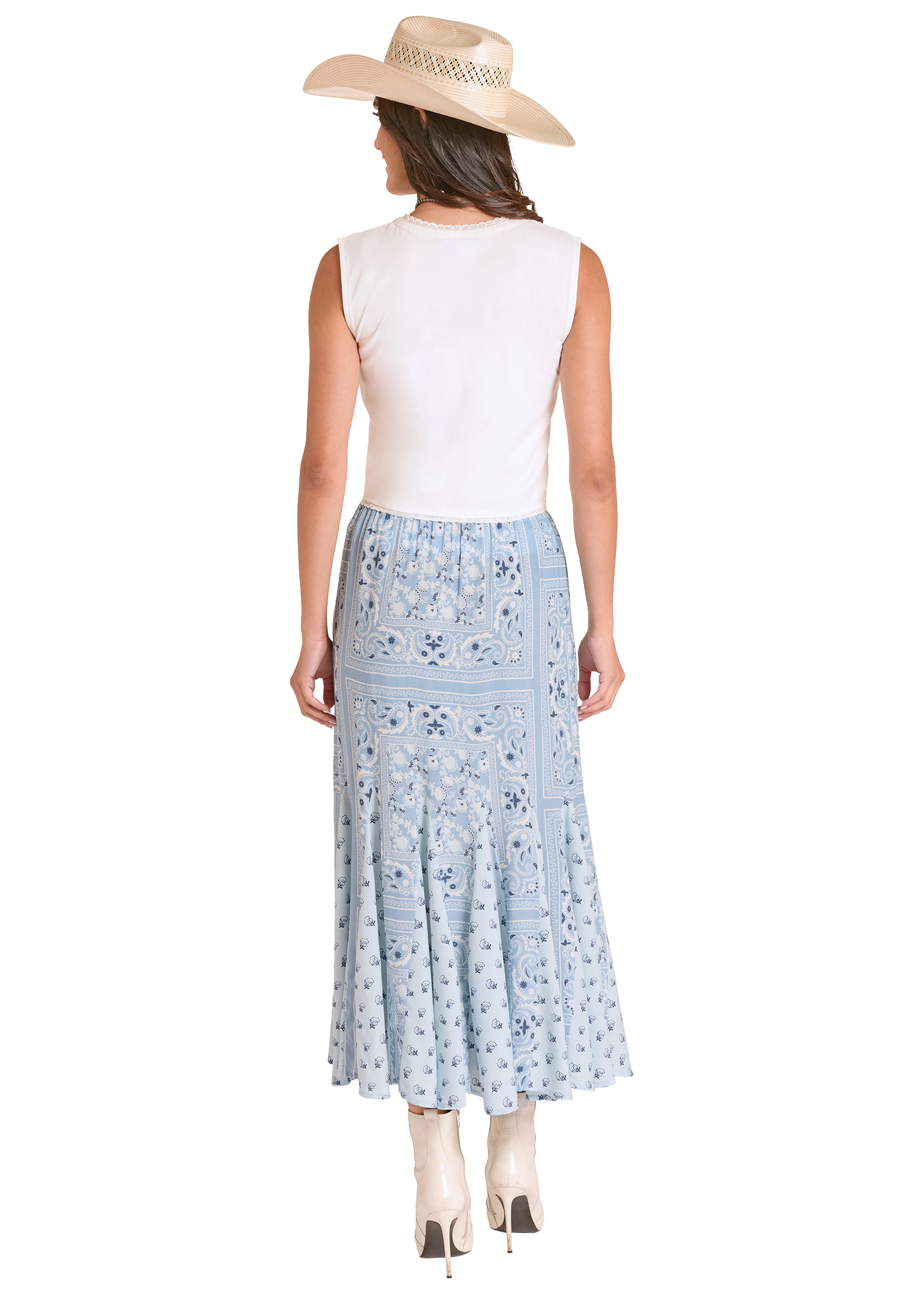 Woman wearing a white sleeveless top and light blue floral skirt with a beige hat on a white background