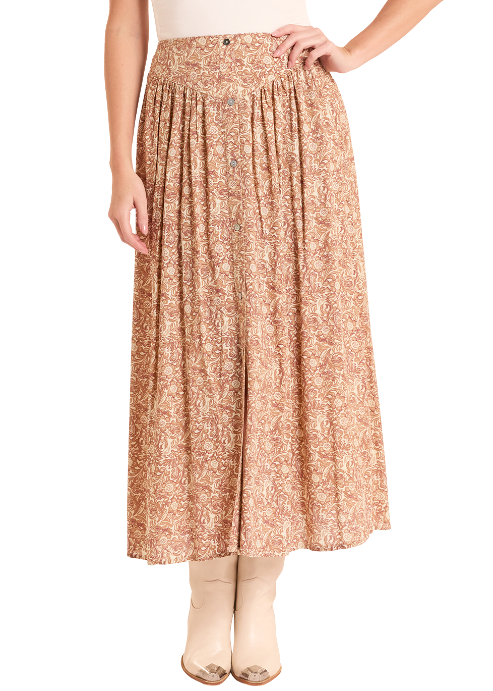 Woman wearing a beige sleeveless top and patterned skirt with a white hat on a white background