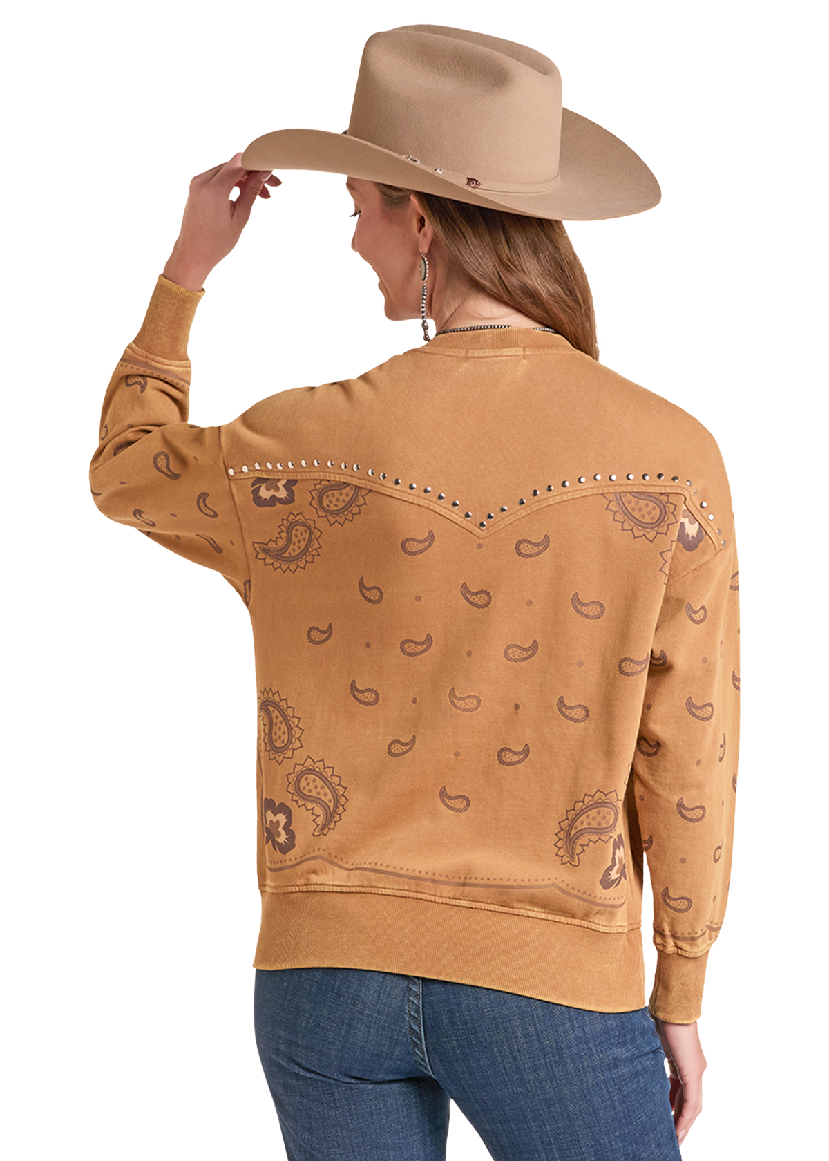 The back of a a tan long-sleeve crewneck sweatshirt with a brown paisley print, paired with blue jeans,