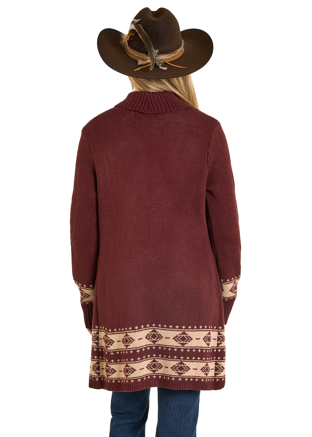 Person wearing a long burgundy sweater with a patterned hem and a brown cowboy hat on a white background