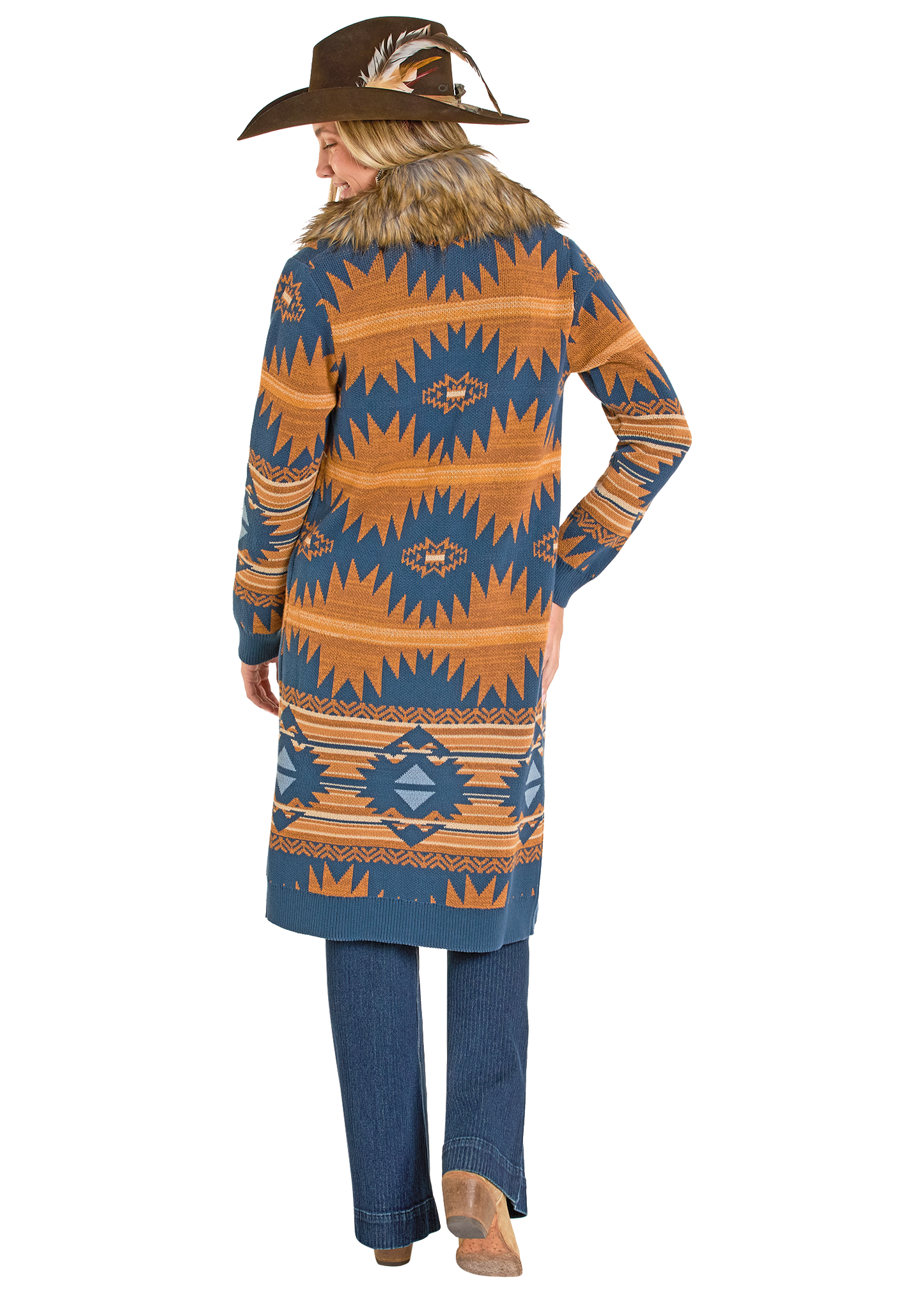 Person wearing a patterned cardigan and jeans on a white background