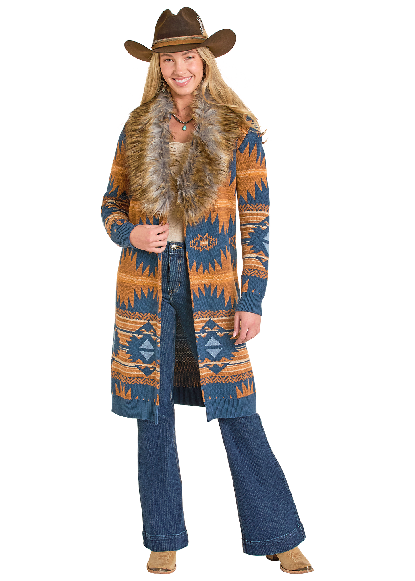 Woman wearing a patterned coat with fur collar and cowboy hat on a white background