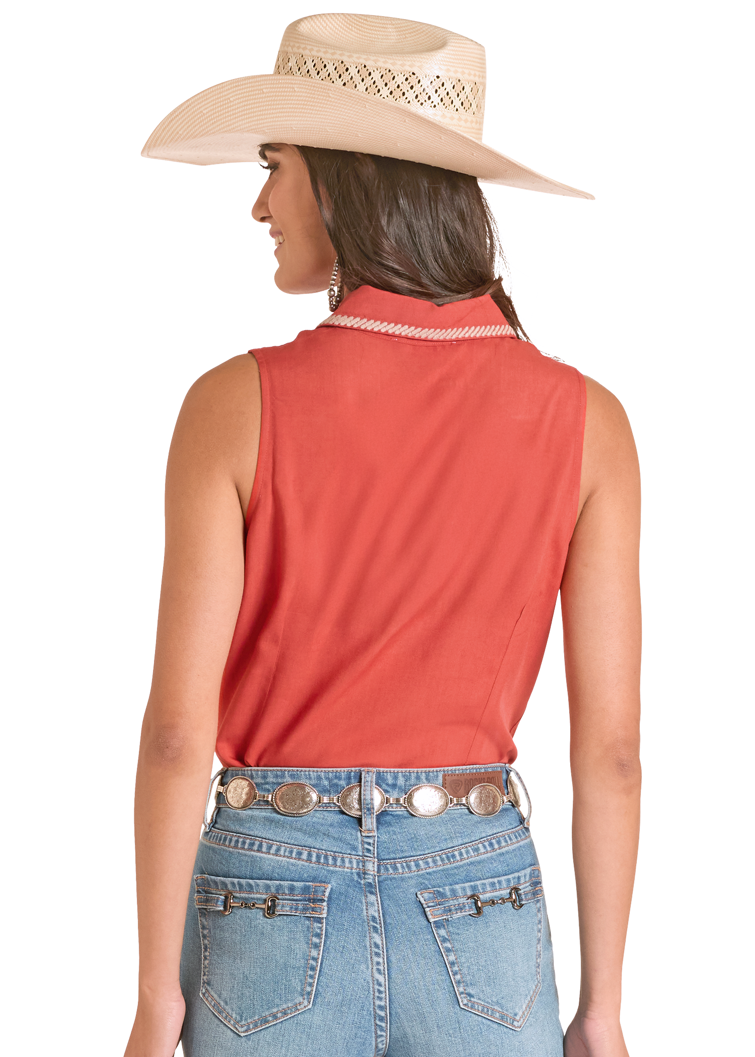 Woman wearing a red sleeveless top, blue jeans, and a beige cowboy hat on a white background