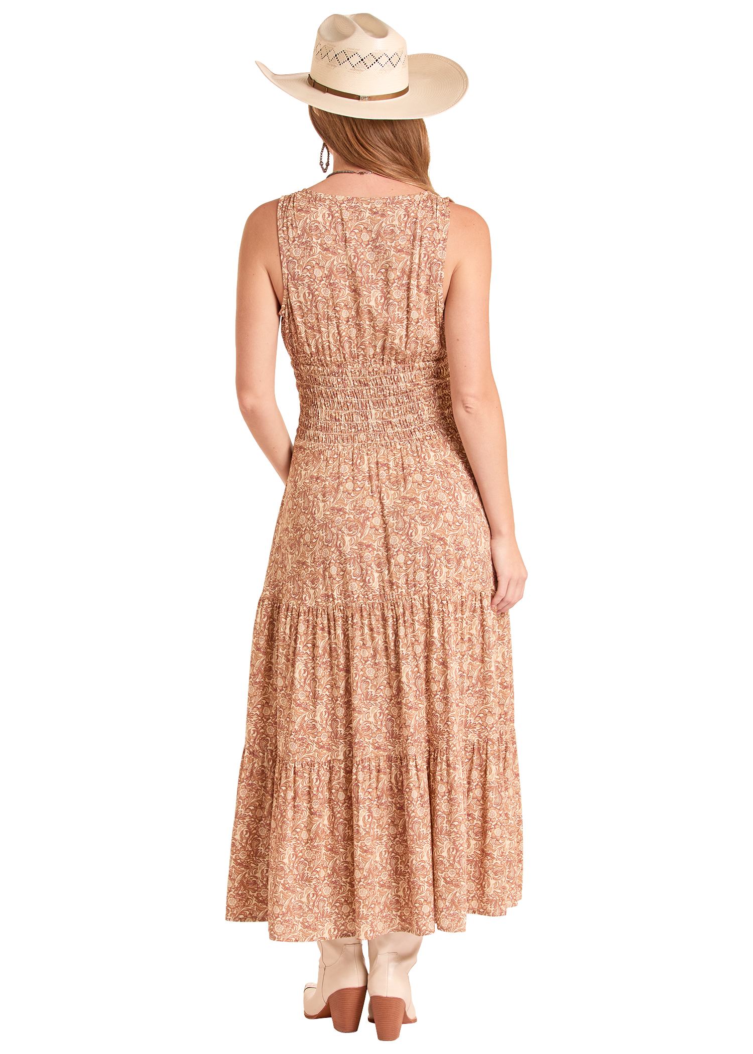 Woman wearing a long, patterned dress with a white background