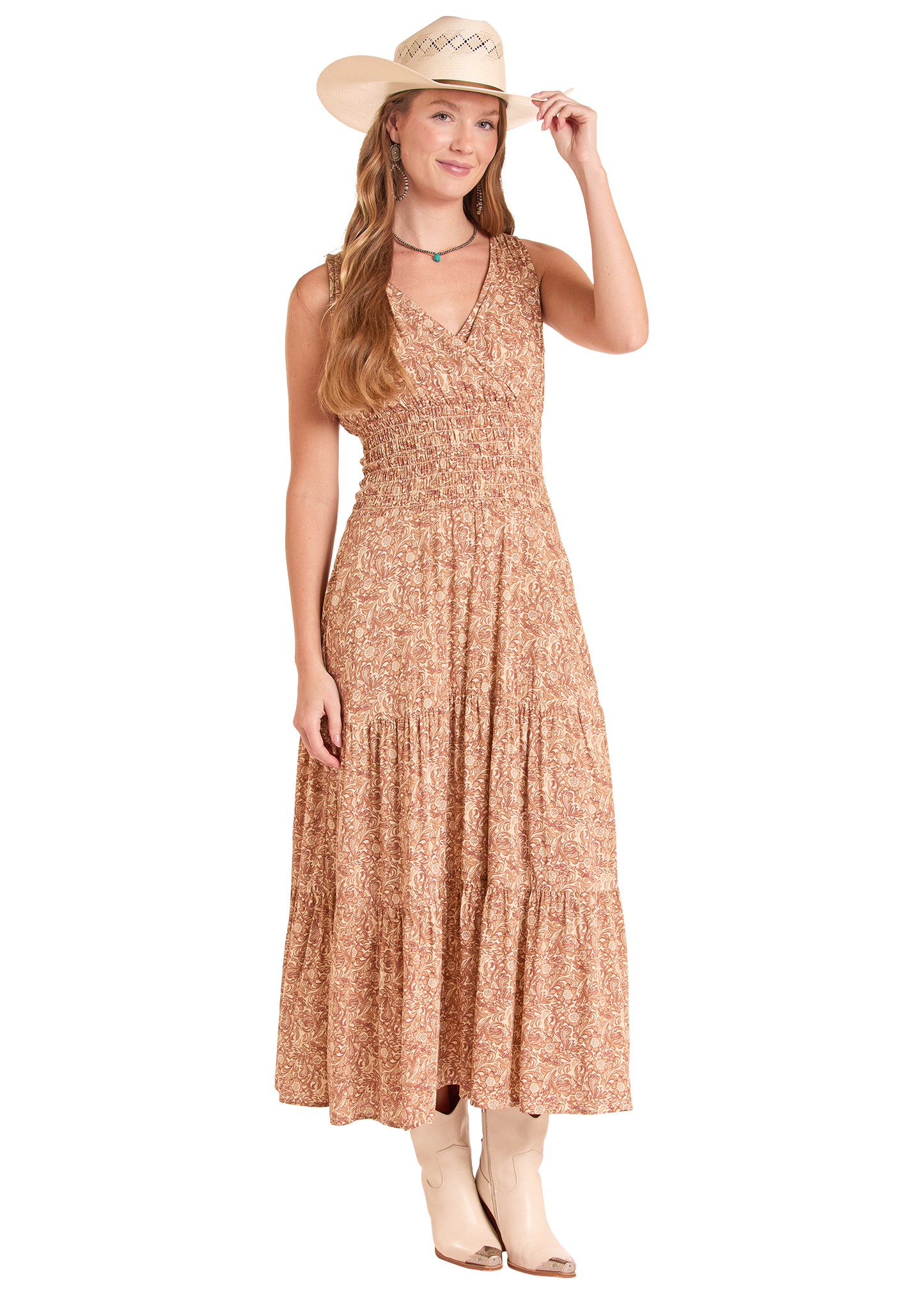 Woman wearing a long floral dress and cowboy hat on a white background