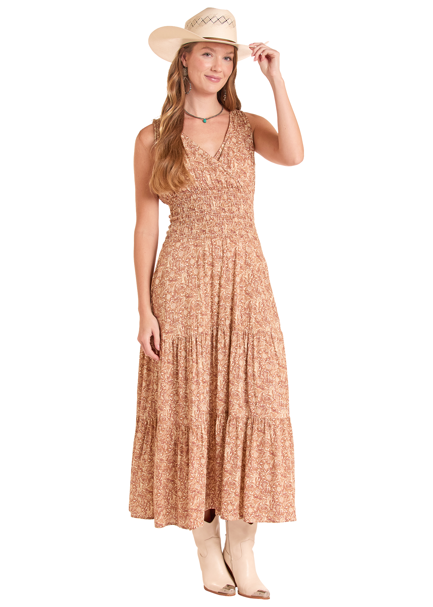 Woman wearing a long floral dress and cowboy hat on a white background