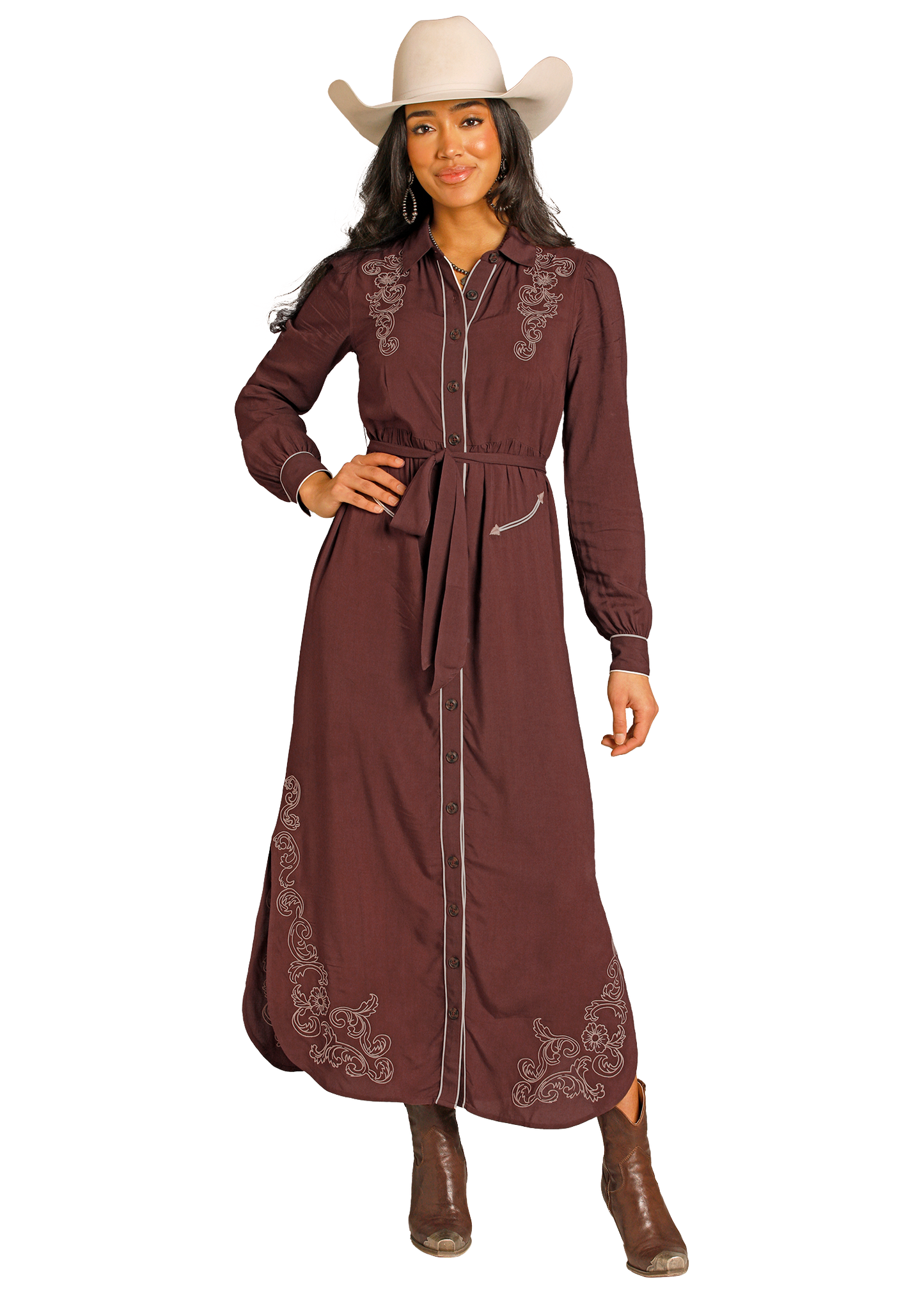 Woman wearing a long brown embroidered dress with a white cowboy hat on a white background