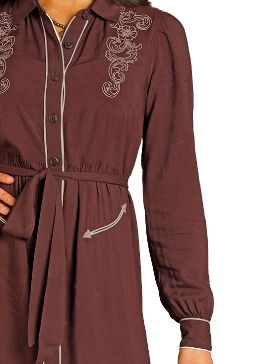 Woman wearing a long brown embroidered dress with a white cowboy hat on a white background