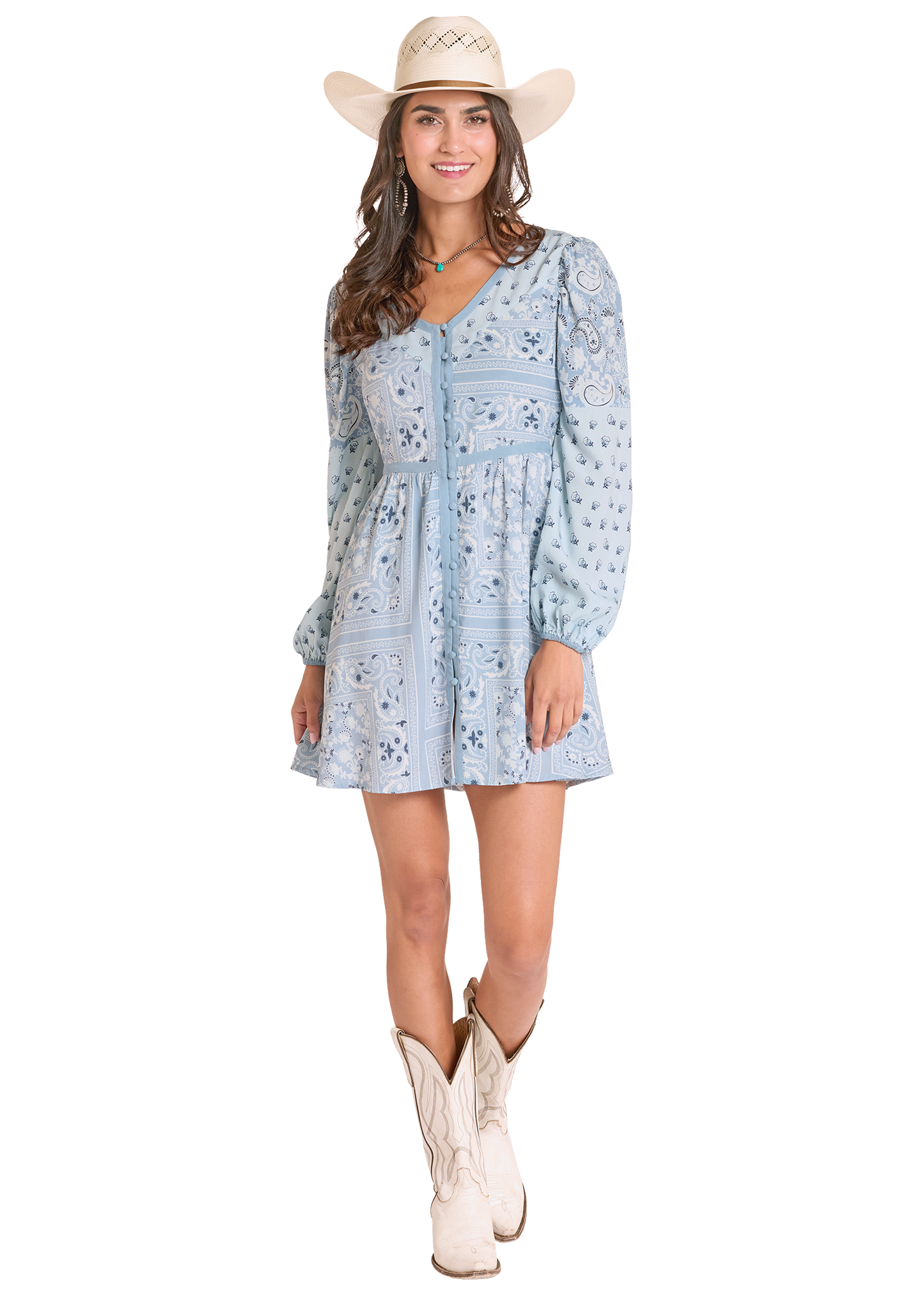Woman wearing a blue floral dress, white cowboy hat, and white boots on a white background