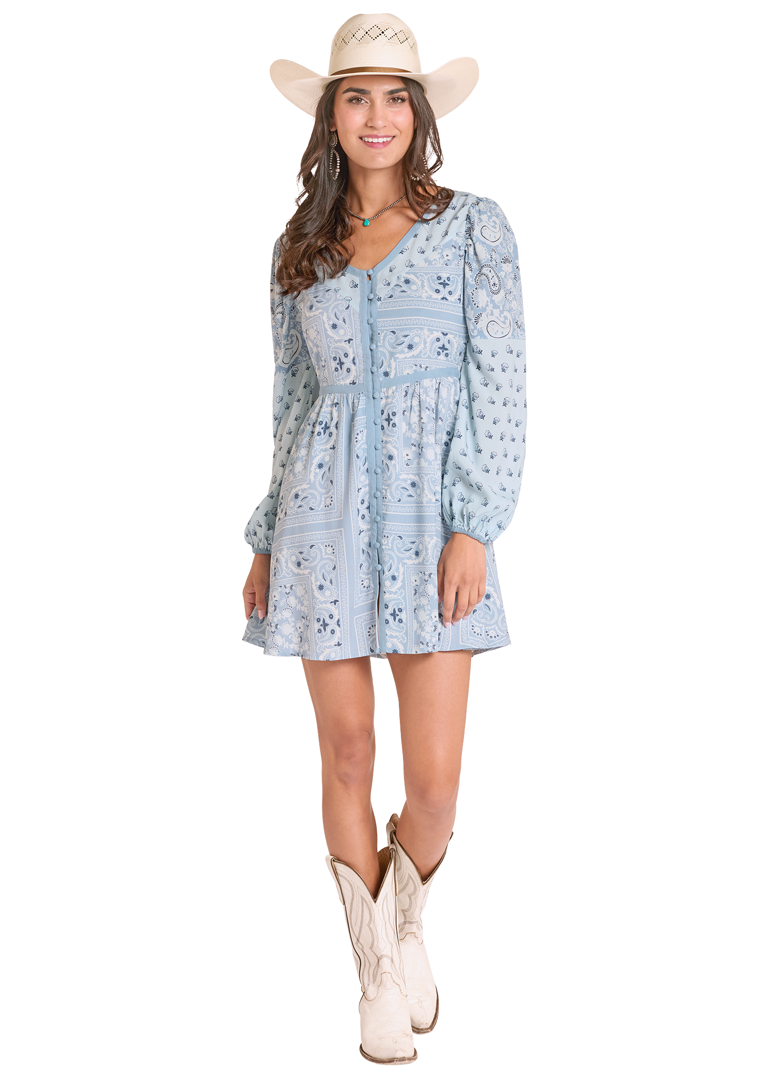 Woman wearing a blue floral dress, white cowboy hat, and white boots on a white background