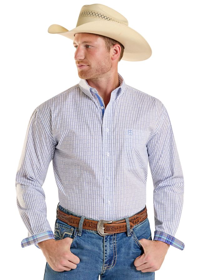 Man wearing a striped shirt, jeans, and a cowboy hat on a white background
