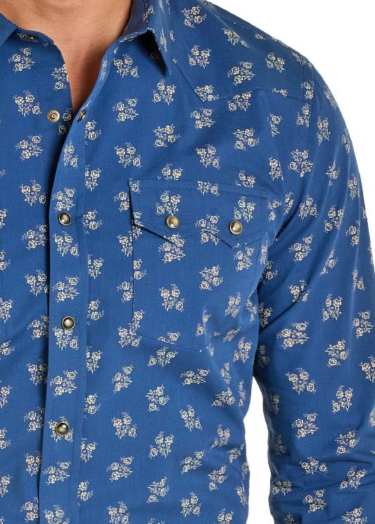 Man wearing a blue patterned shirt, jeans, and a beige cowboy hat on a white background