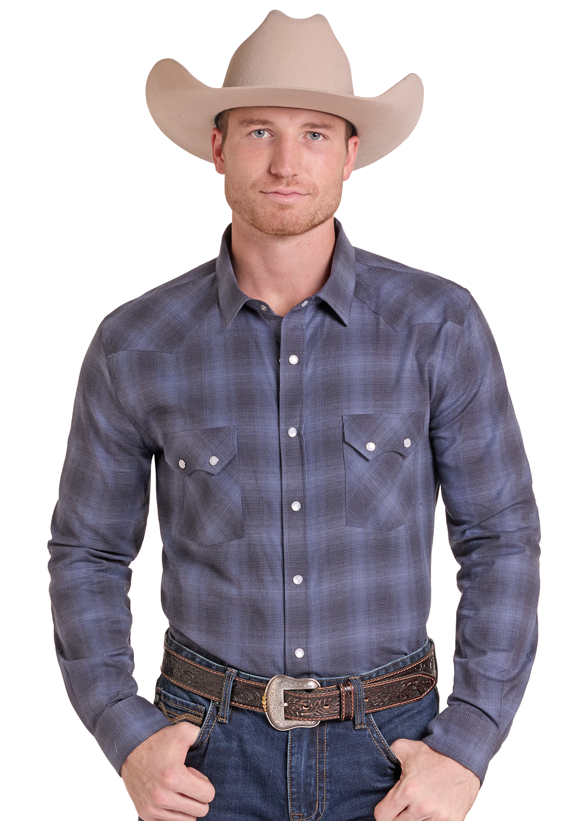 A man wearing a long-sleeve western plaid shirt in slate blue and gray, paired with a tan cowboy hat, brown belt, and blue jeans.