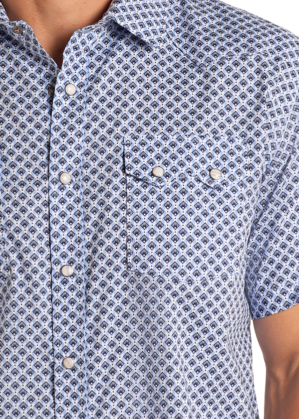 Man wearing a blue patterned short-sleeve shirt on a white background