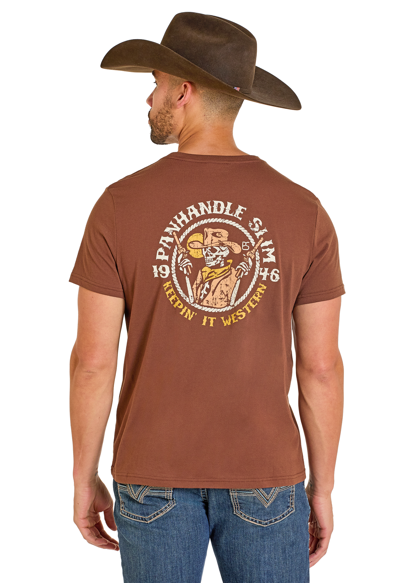 Man wearing a brown t-shirt with a logo and text, standing against a white background