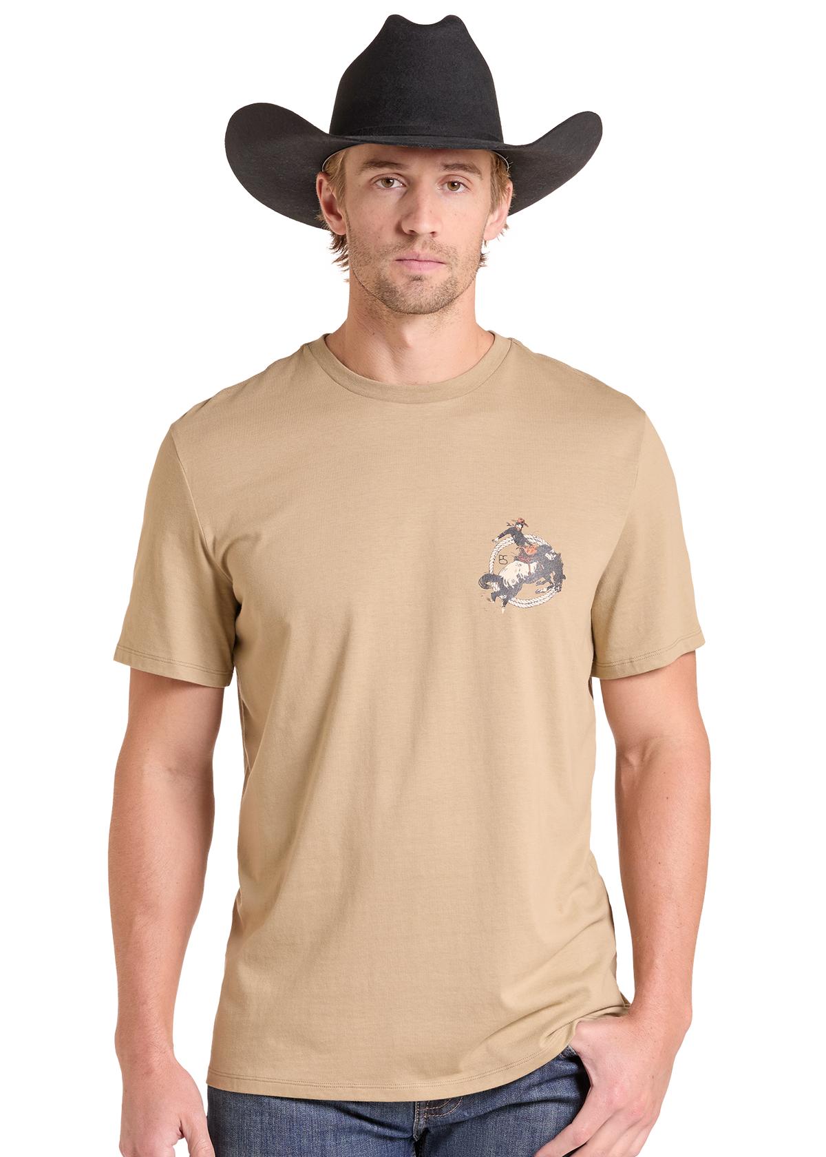 A man wearing a tan crewneck t-shirt with a small western-themed graphic on the left chest, paired with a black cowboy hat and blue jeans, set against a plain white background.