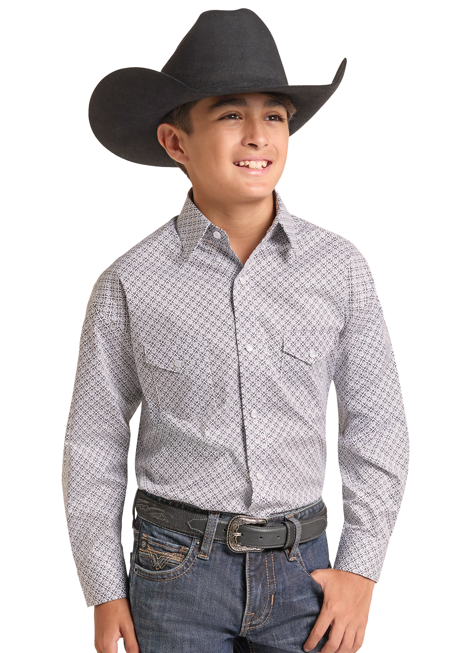 A young boy wearing a black cowboy hat, a light gray and white patterned western long-sleeve button-down shirt, and blue jeans.