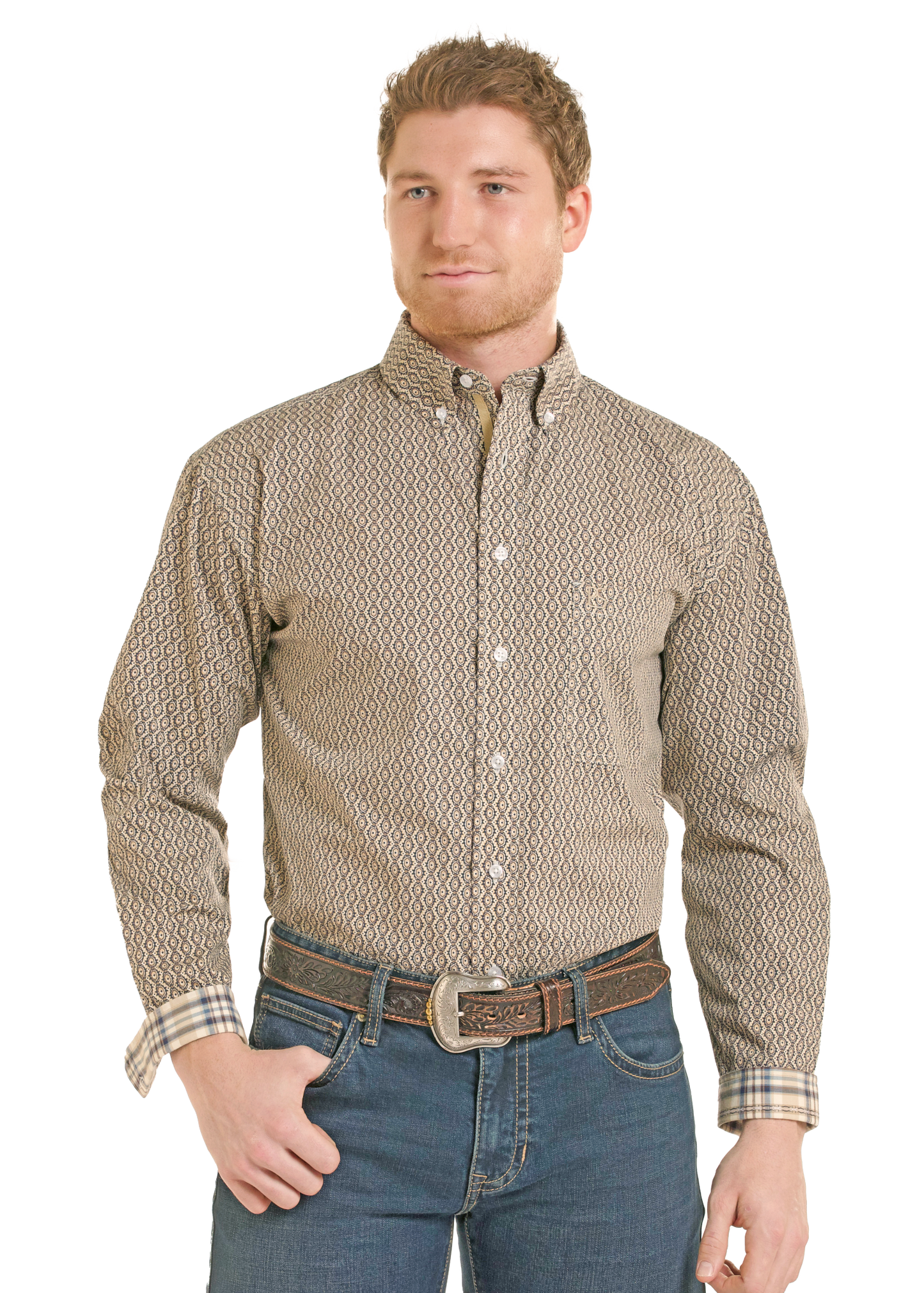 A man wearing a long-sleeve button-down shirt with a beige and brown geometric pattern, paired with blue jeans and a brown belt.