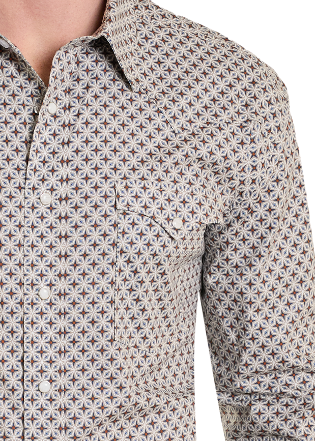 Man wearing a patterned shirt and jeans on a white background
