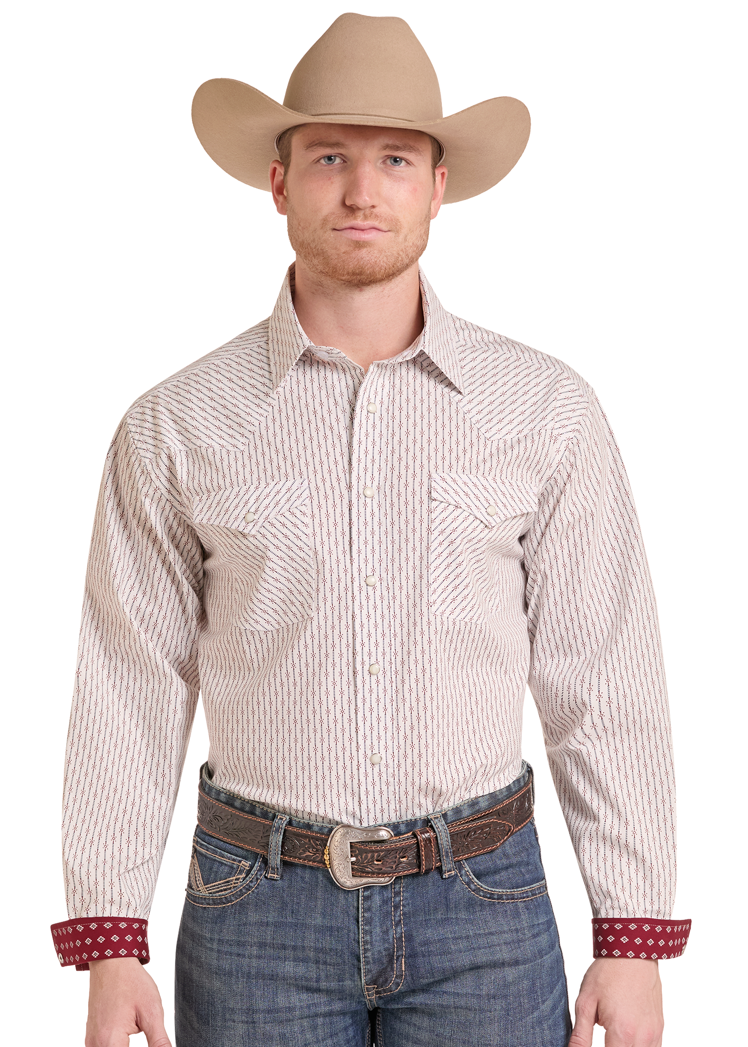 A man wearing a tan cowboy hat, a beige and brown vertically striped western long-sleeve button-down shirt, blue jeans, and a brown leather belt.