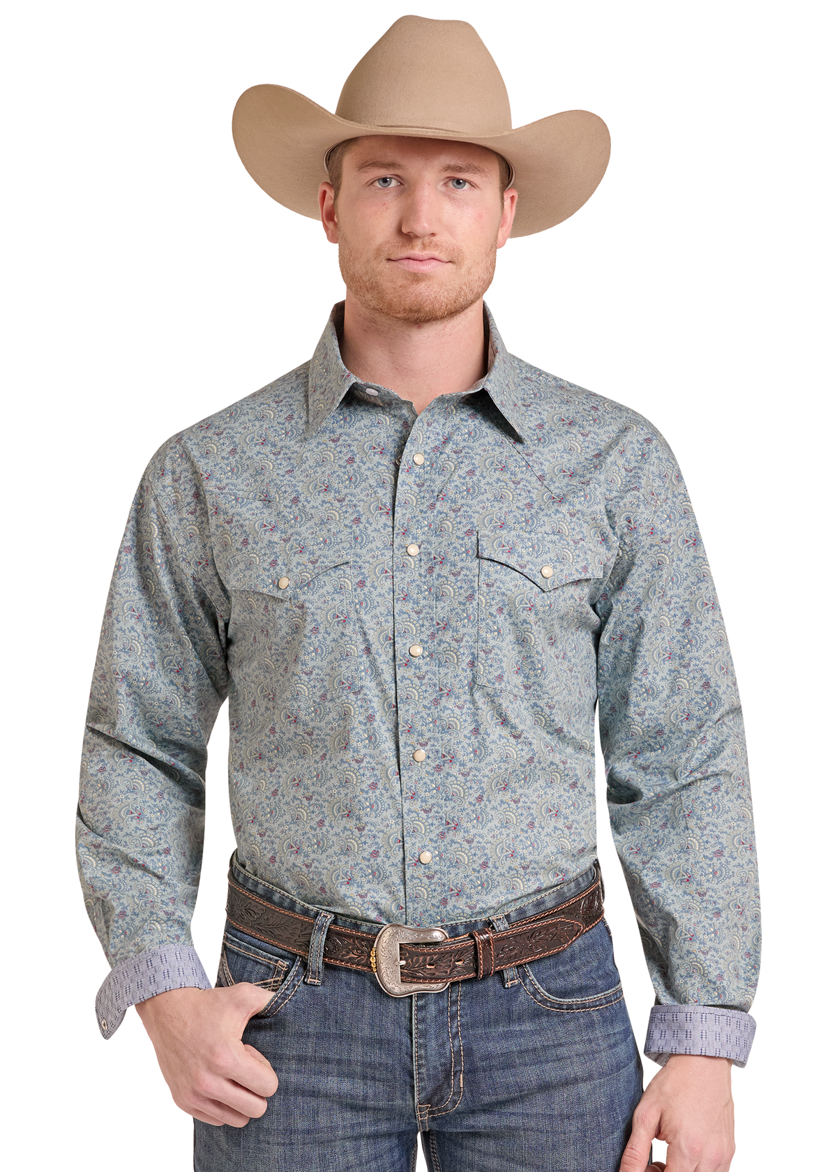 A man wearing a light blue and gray patterned western long-sleeve button-down shirt, a tan cowboy hat, and blue jeans.