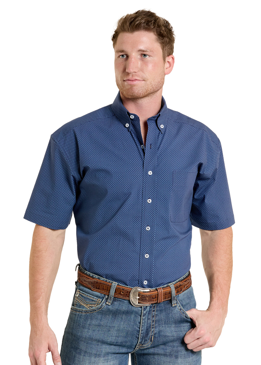 Man wearing a blue patterned shirt and jeans on a white background
