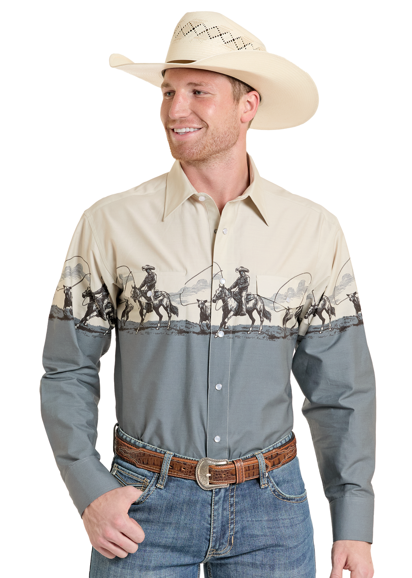 Man wearing a western shirt featuring a cowboy on a horse roping a calf