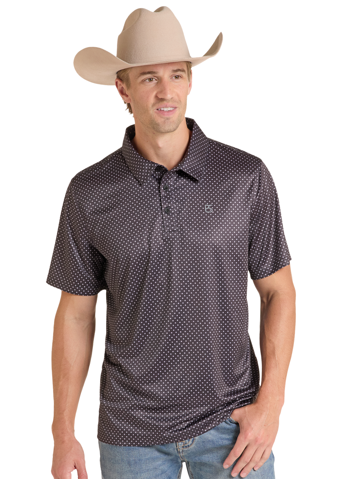 A man wearing a beige cowboy hat and a dark brown short-sleeve polo shirt with a white micro-dot pattern, paired with blue jeans, photographed against a solid white background.