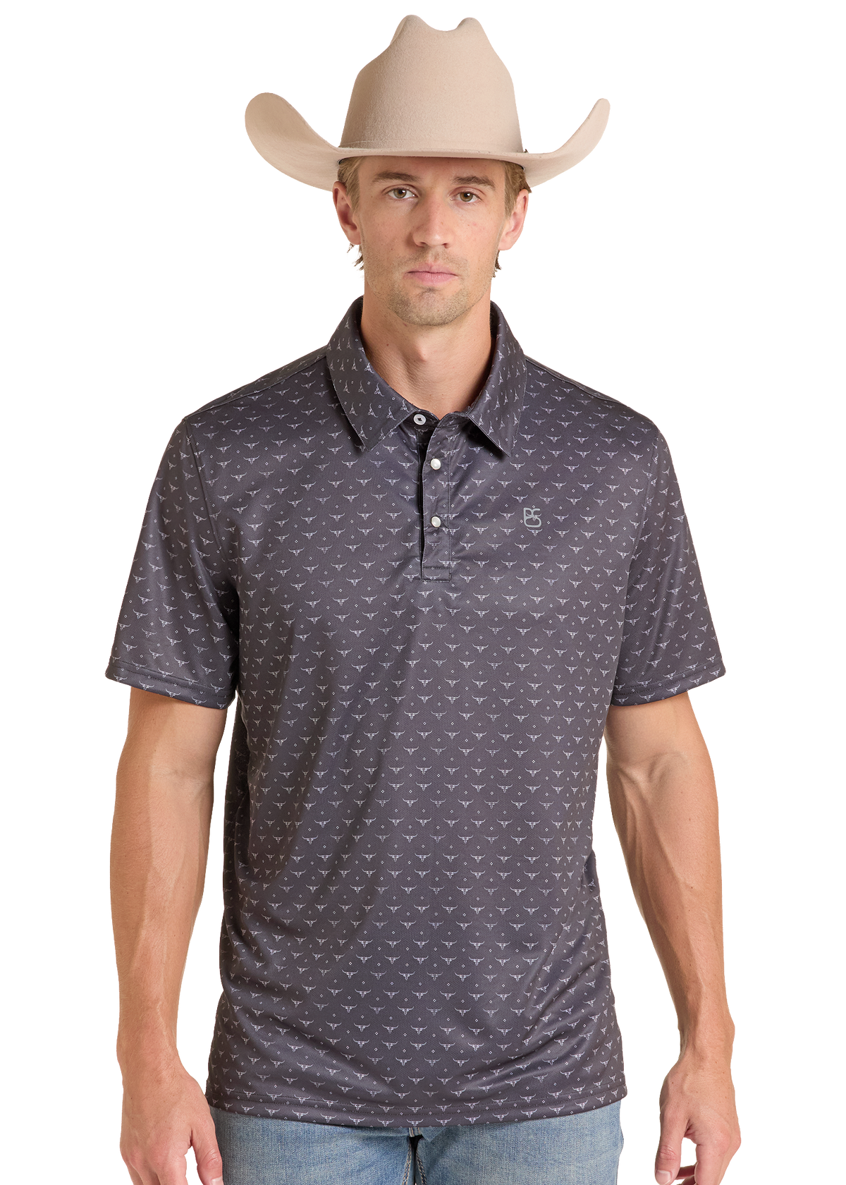 A man wearing a dark gray short-sleeve polo shirt with a small repeating white pattern, paired with a beige cowboy hat and light blue jeans, against a plain white background.