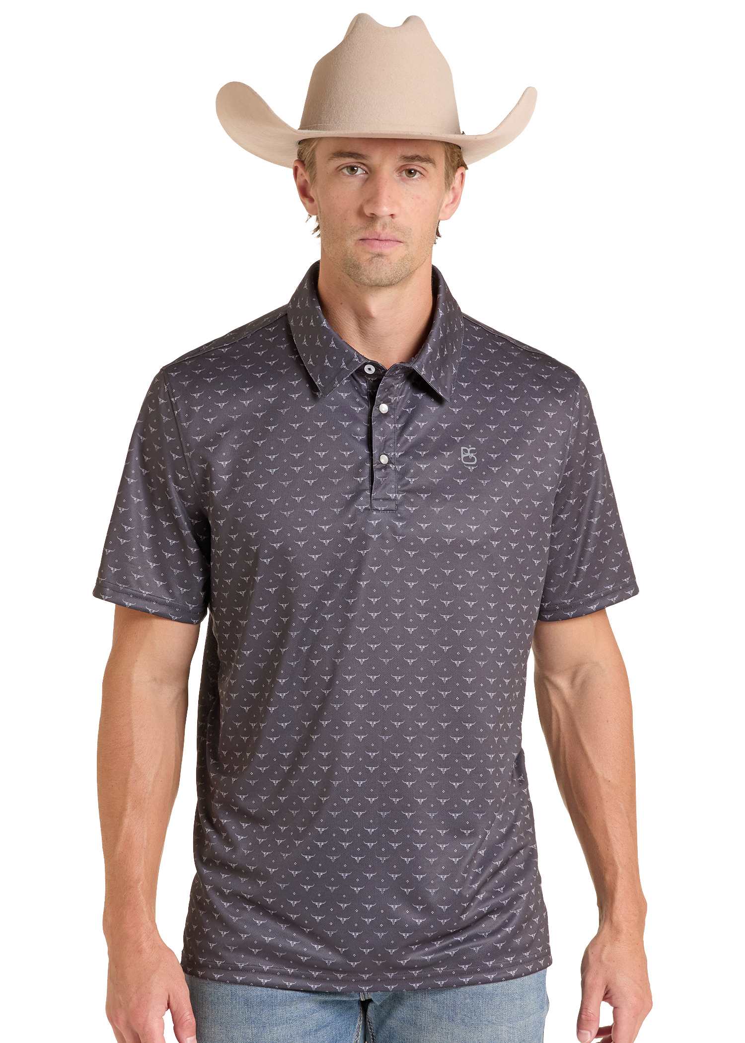 A man wearing a dark gray short-sleeve polo shirt with a small repeating white pattern, paired with a beige cowboy hat and light blue jeans, against a plain white background.
