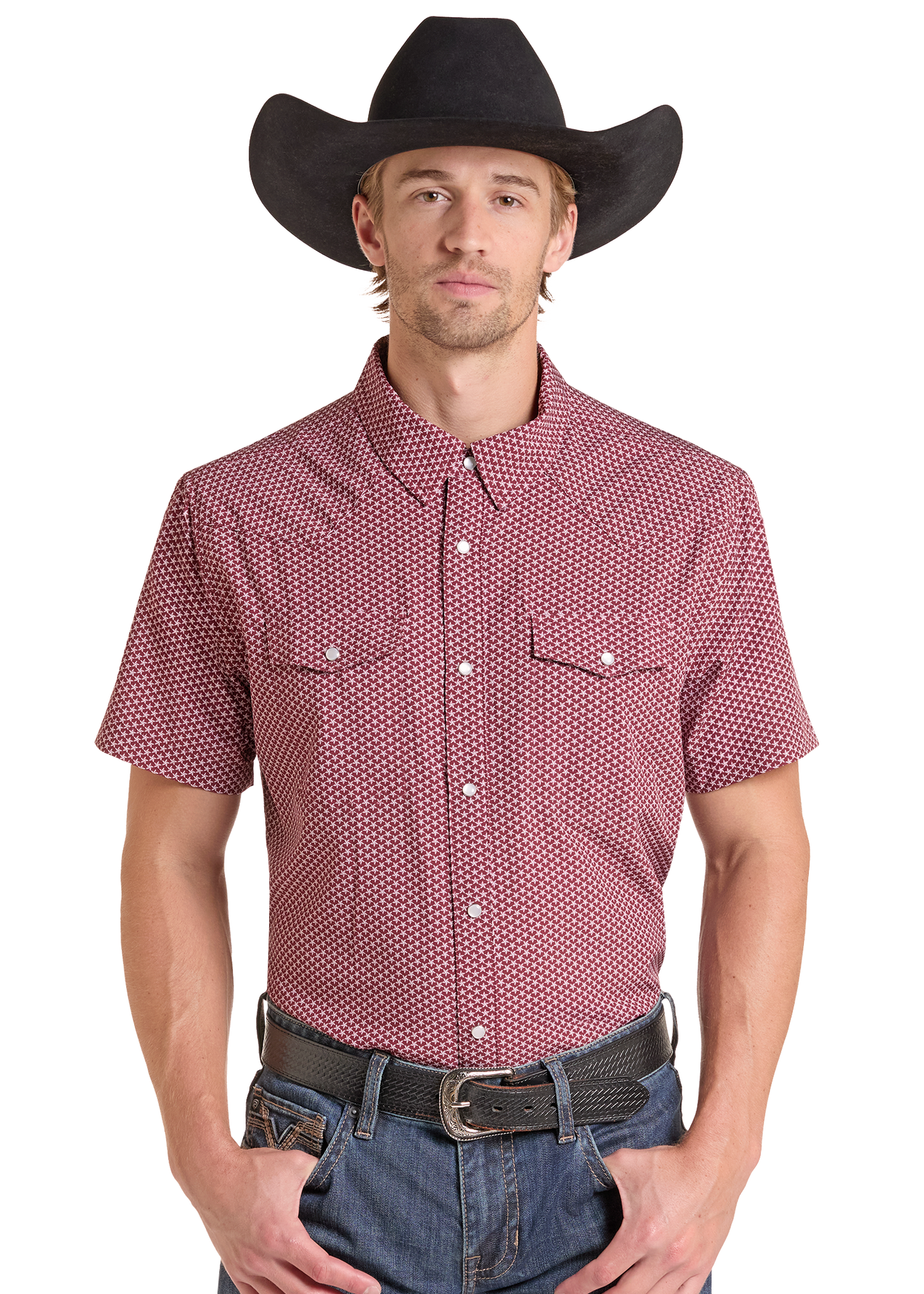 A man wearing a short-sleeve button-up western shirt with a red and white micro-dot pattern, a black cowboy hat, and blue jeans, photographed against a solid white background.