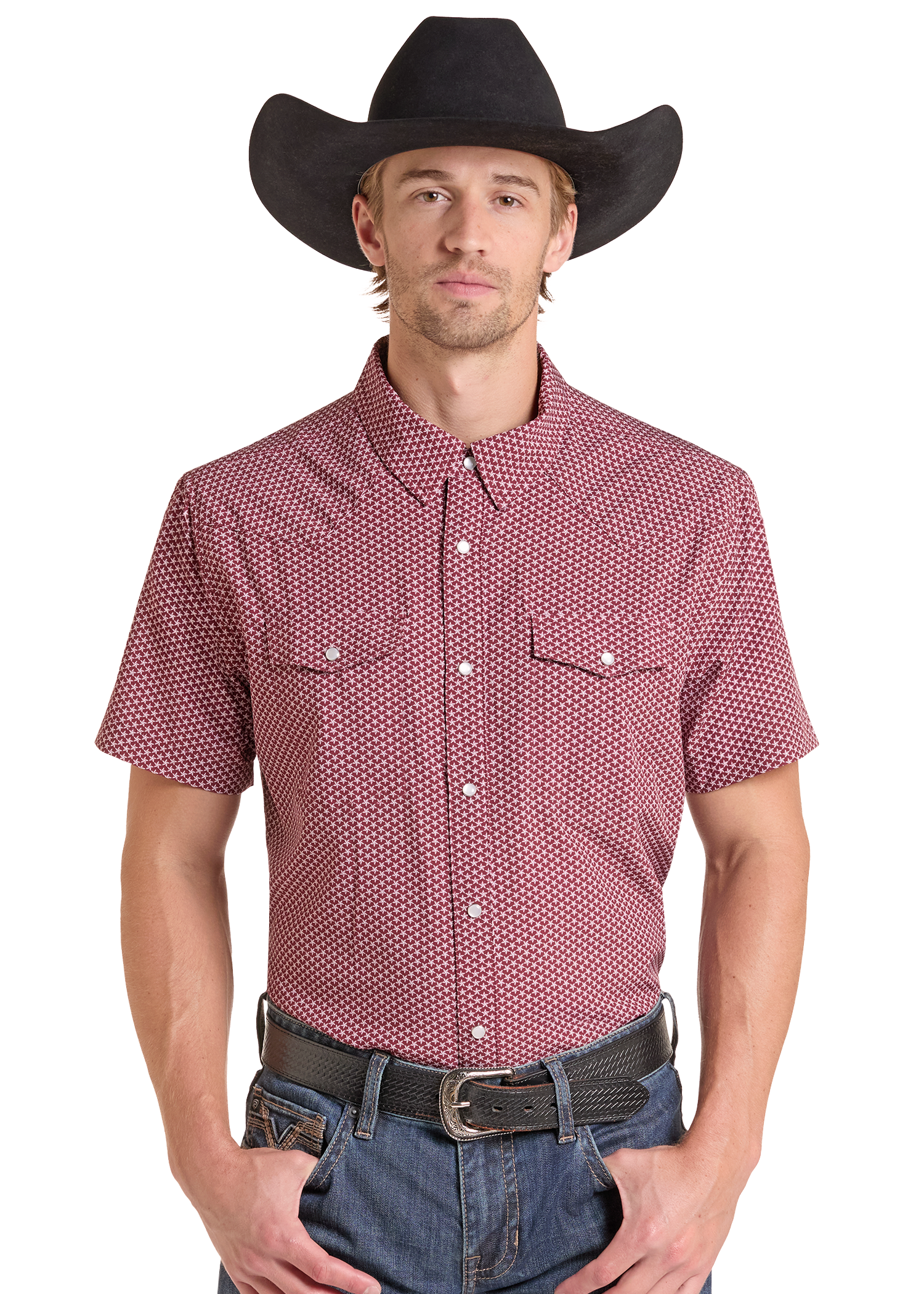 A man wearing a short-sleeve button-up western shirt with a red and white micro-dot pattern, a black cowboy hat, and blue jeans, photographed against a solid white background.