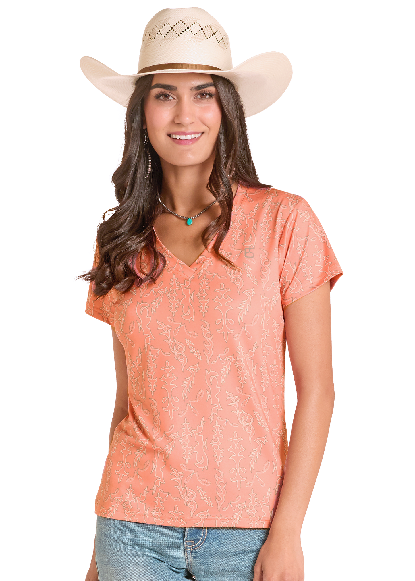 Woman wearing a peach-colored top and beige cowboy hat on a white background