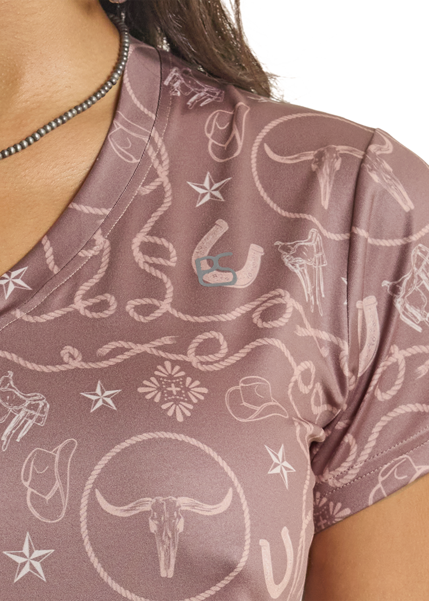 Close-up of a brown shirt with white patterns and a visible brand logo.