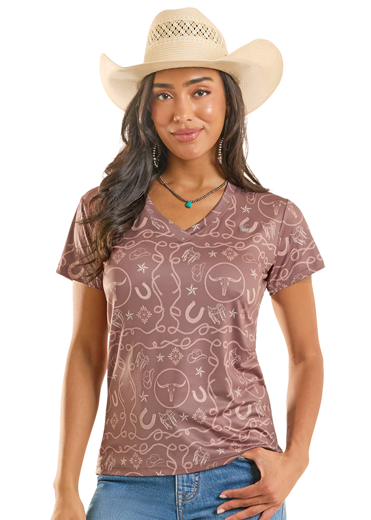 Woman wearing a patterned brown shirt and blue jeans with a beige cowboy hat on a white background
